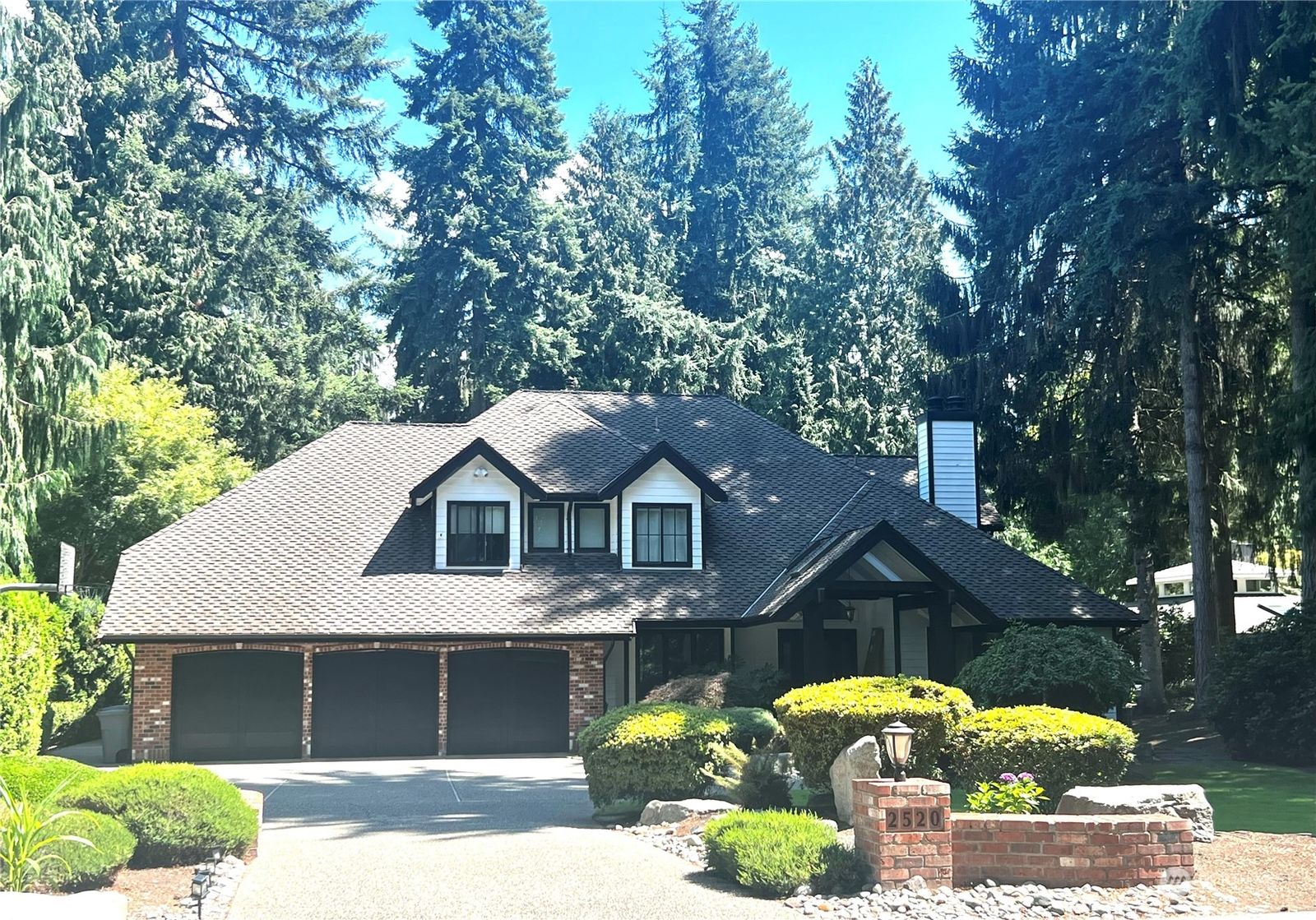 2520 Sahalee Drive West, Sammamish, framed by tall evergreens