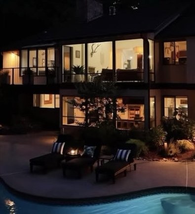 Sahalee Country Club Estates home with a lit pool at dusk